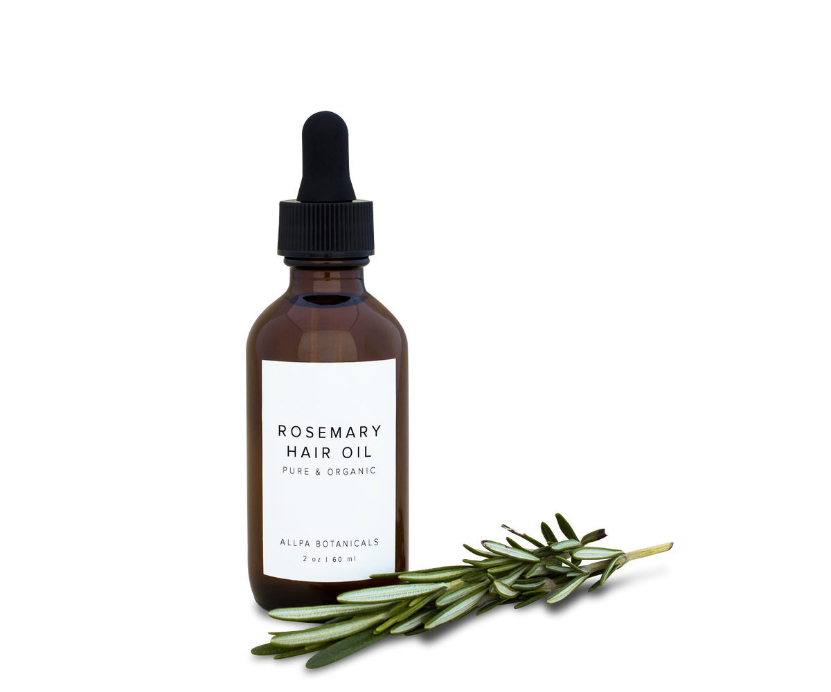 Bottle of rosemary hair oil with a sprig of fresh rosemary
